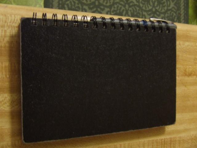 Pen being stored in the ring binding of the notebook
